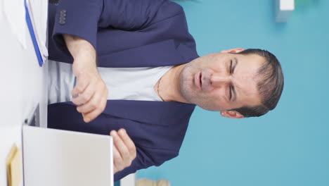 Vertical-video-of-Businessman-looking-scared-at-laptop.